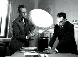 The brothers Achille and Pier Giacomo Castiglioni with the Taccia table lamp.