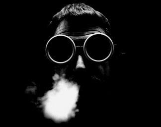 Ettore Sottsass with welding goggles and smoke on his face